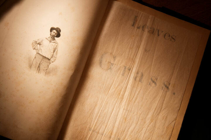A close-up of a book with the cover opened and an image of Walt Whitman.