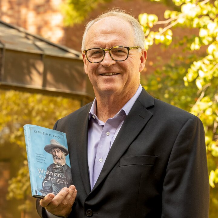 Photo of Ken Price holding his book titled Whitman in Washington.